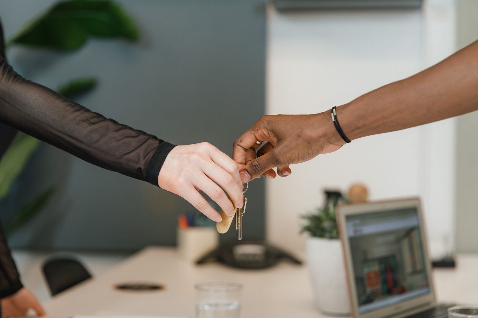 Staff handing over keys across a desk