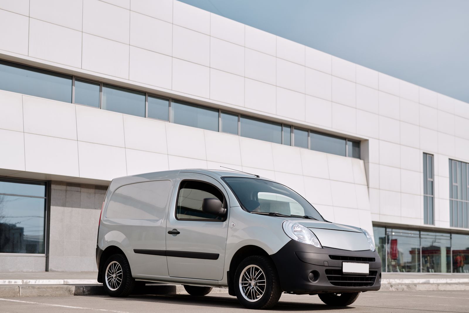 High-roof cargo van parked outside an office building