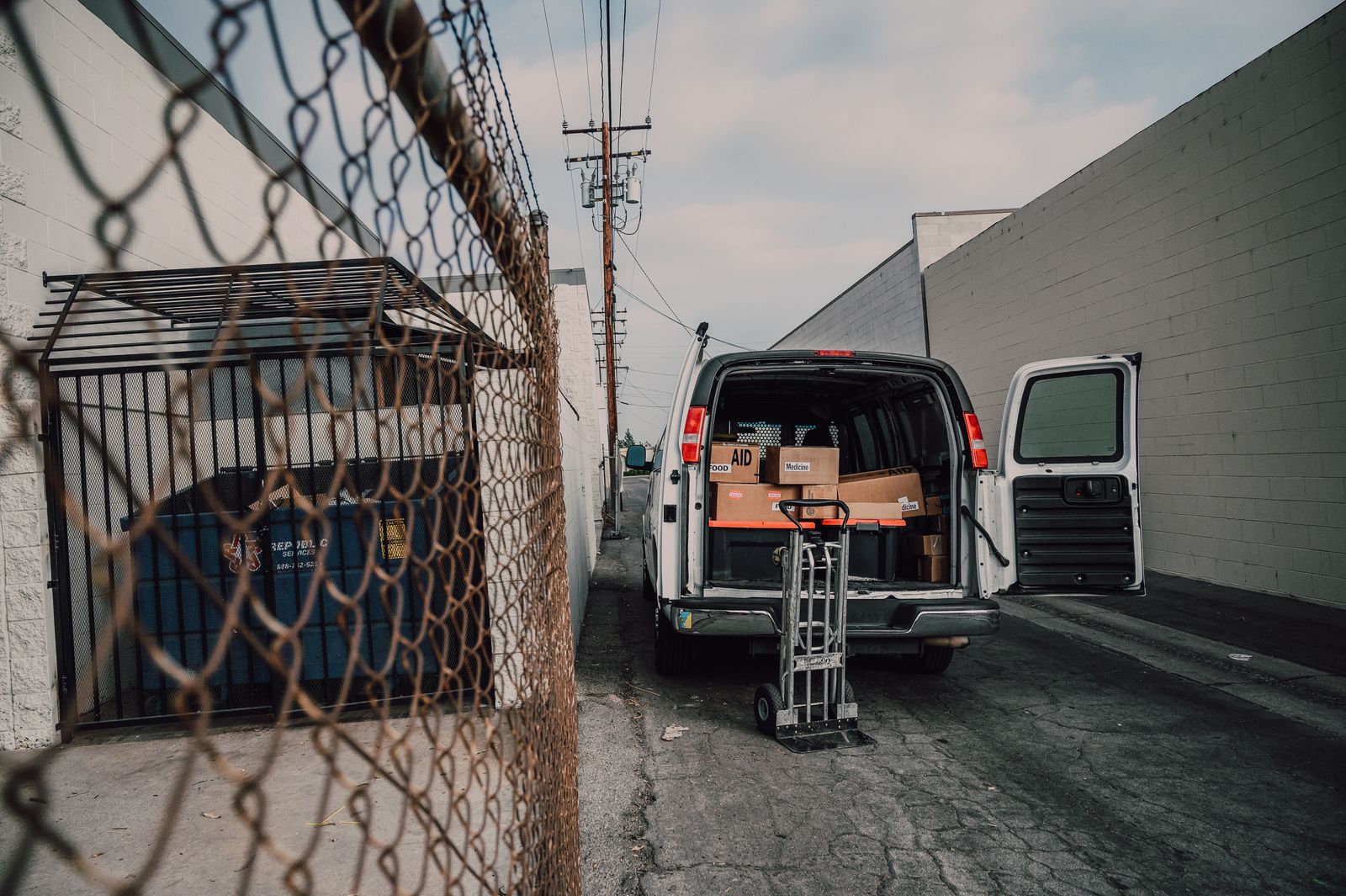 Open van loaded with boxes in an alley